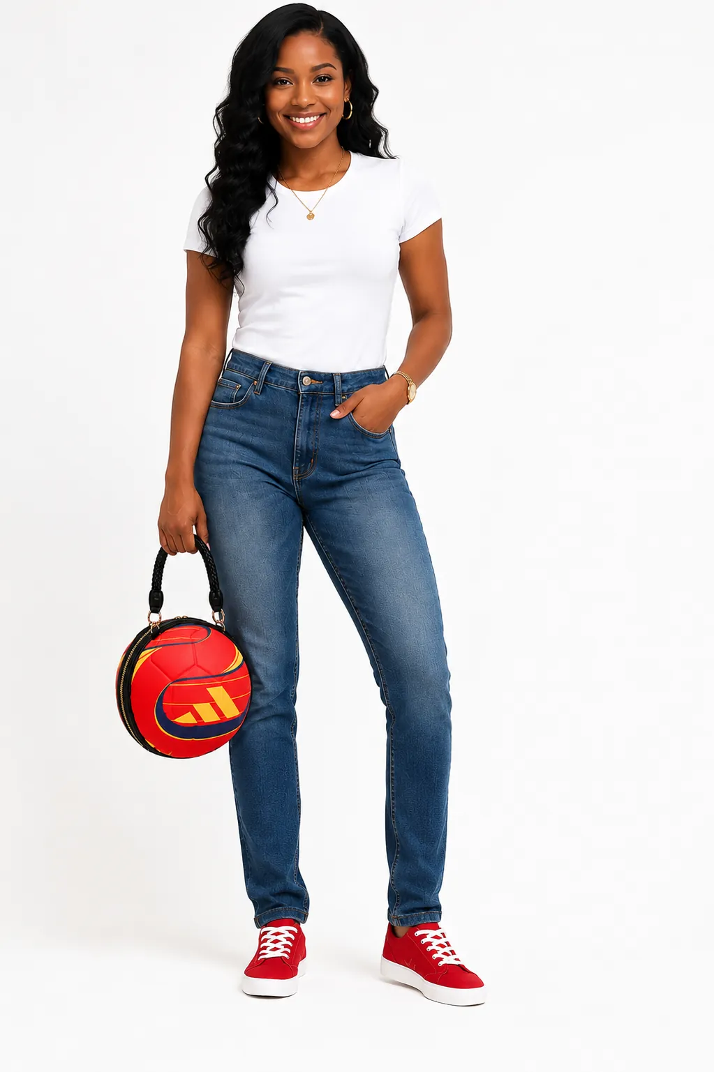 Model in a white tee and jeans carrying The Inspiring Ball Bag — a red soccer-ball shaped handbag with a braided black handle